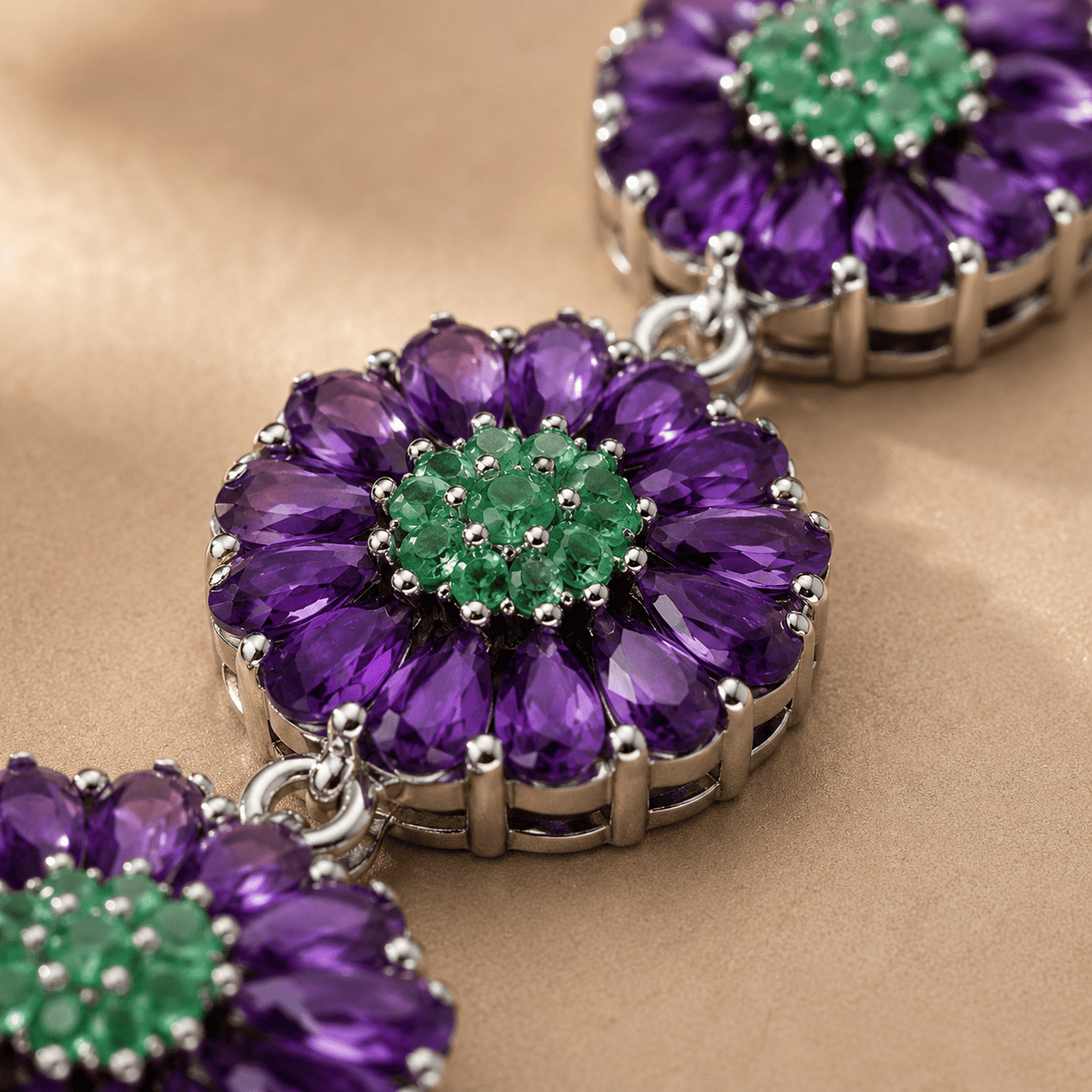 Close up of African amethyst and Zambian emerald gemstones in handcrafted sterling silver bracelet