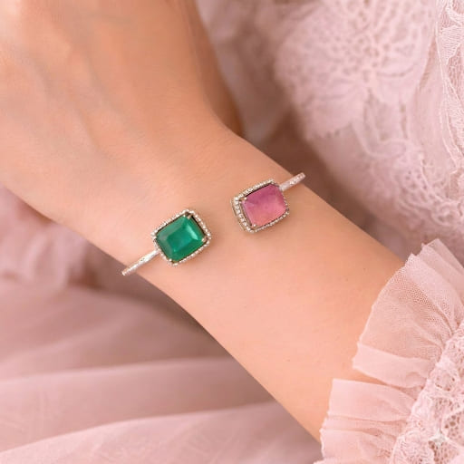 Contemporary silver cuff bracelet featuring octagon emerald and cushion ruby
