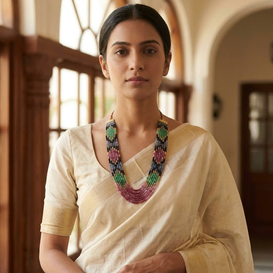 Woman wearing multi gemstone beaded necklace with cream saree